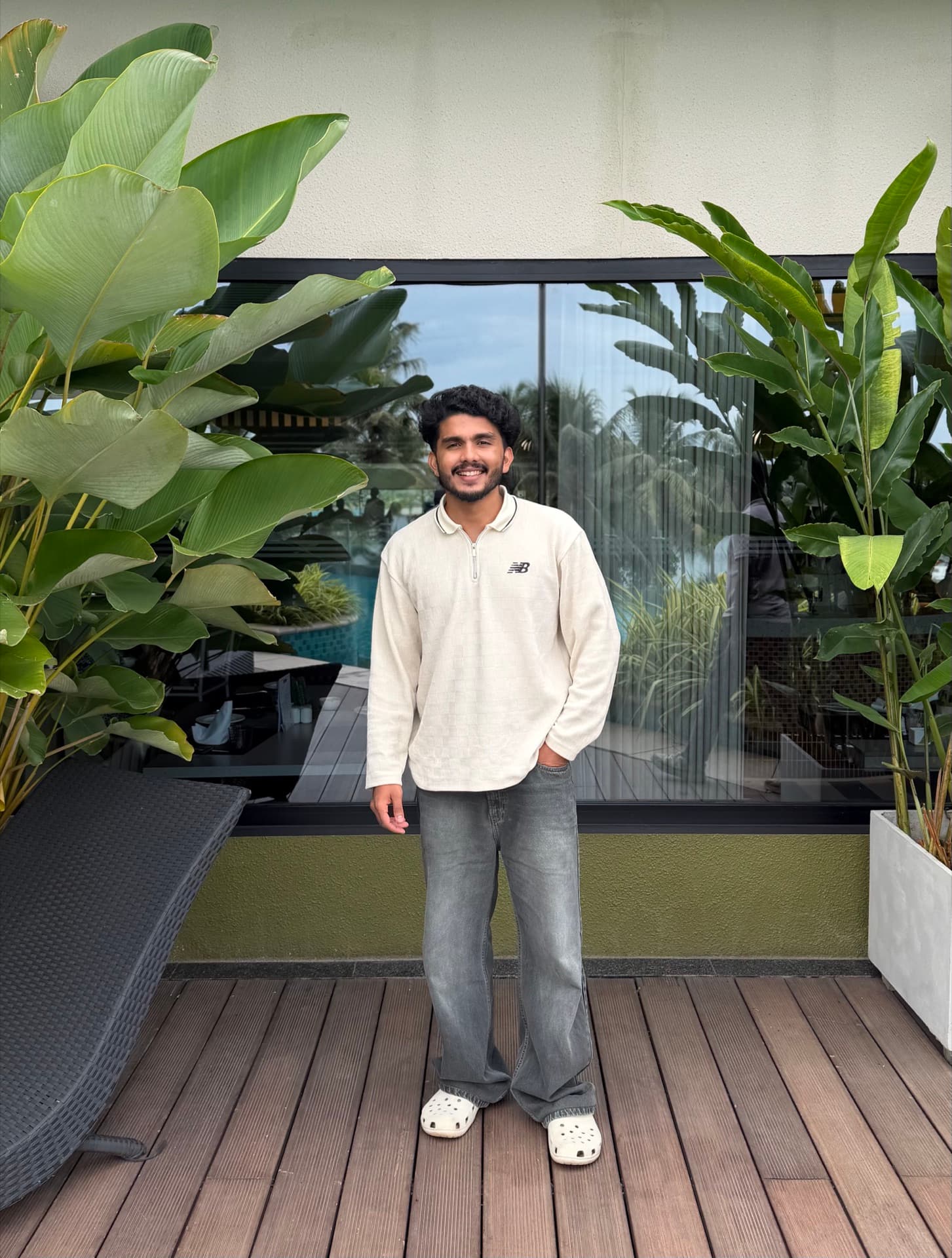 Fawas, standing on a plant-lined deck